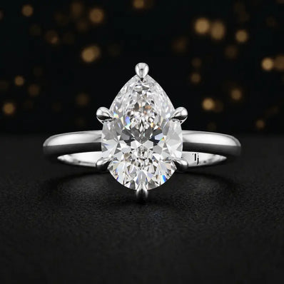 Front view of a 1.5 carat pear cut diamond solitaire engagement ring in an 18kt white gold 6 claw setting by TJ Diamond