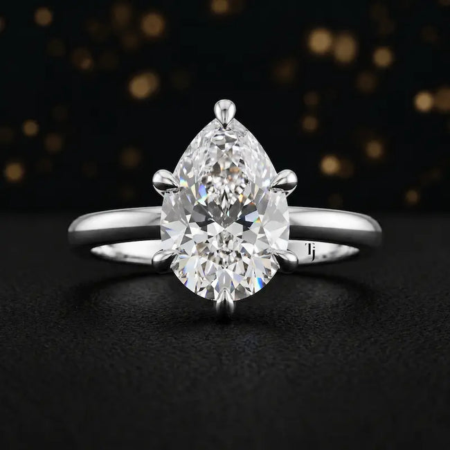 Front view of a 1.5 carat pear cut diamond solitaire engagement ring in an 18kt white gold 6 claw setting by TJ Diamond