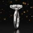 Side profile of a 1.5 carat pear cut diamond solitaire engagement ring showing the cathedral setting and 18kt white gold band by TJ Diamond