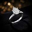 Front-on view of a 1.5 carat pear cut diamond solitaire engagement ring showing the full 18kt white gold band and 6 claw cathedral setting by TJ Diamond