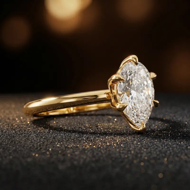 Angled side view of a 1.5 carat pear cut diamond solitaire engagement ring in an 18kt yellow gold 6 claw setting by TJ Diamond
