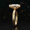 Front-on view of a 1.5 carat pear cut diamond solitaire engagement ring showing the full 18kt yellow gold band and 6 claw cathedral setting by TJ Diamond