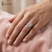 Oval Lab-Created Pink Diamond Halo Ring in 18kt white gold worn on hand featuring an oval pink diamond surrounded by round brilliant lab-grown diamonds.