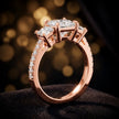 Angled view of a princess cut three-stone lab-grown diamond engagement ring in 18kt rose gold with diamond shoulders