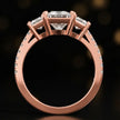 Front-on view of a princess cut three-stone lab-grown diamond engagement ring in 18kt rose gold showing the setting profile