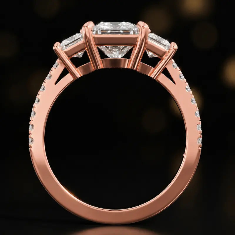 Front-on view of a princess cut three-stone lab-grown diamond engagement ring in 18kt rose gold showing the setting profile