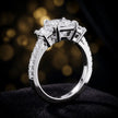 Angled view of a princess cut three-stone lab-grown diamond engagement ring in 18kt white gold with diamond shoulders