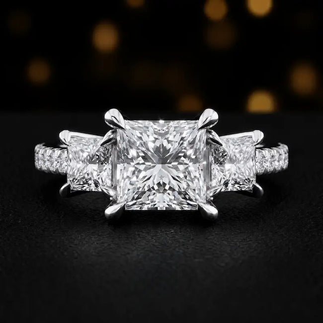 Front view of a princess cut three-stone lab-grown diamond engagement ring in 18kt white gold with diamond shoulders