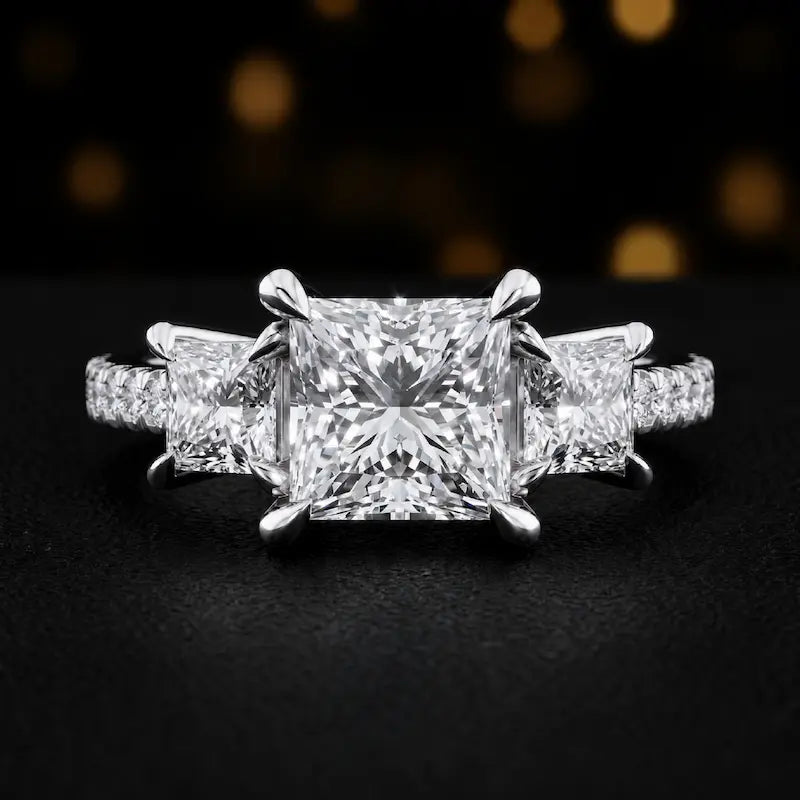 Front view of a princess cut three-stone lab-grown diamond engagement ring in 18kt white gold with diamond shoulders