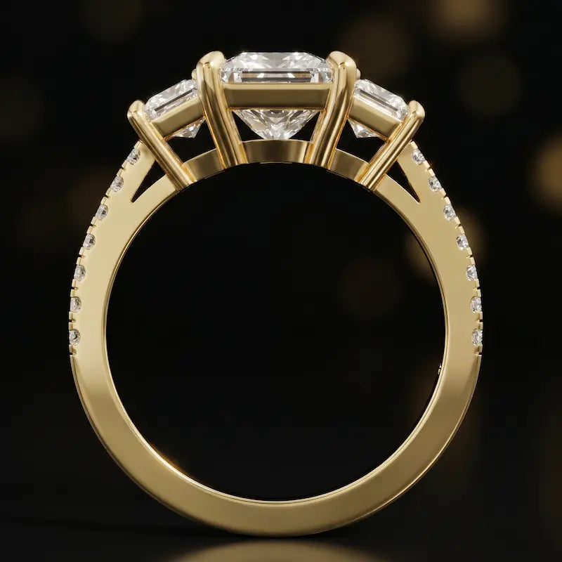Front-on view of a princess cut three-stone lab-grown diamond engagement ring in 18kt yellow gold showing the setting profile