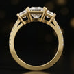Front-on view of a princess cut three-stone lab-grown diamond engagement ring in 18kt yellow gold showing the setting profile