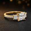 Side view of a princess cut three-stone lab-grown diamond engagement ring in 18kt yellow gold with diamond shoulders
