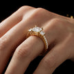 Princess cut three-stone lab-grown diamond engagement ring in 18kt yellow gold with diamond shoulders worn on hand