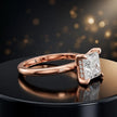 Angled view of 4-claw princess cut engagement ring with hidden halo in 18kt rose gold