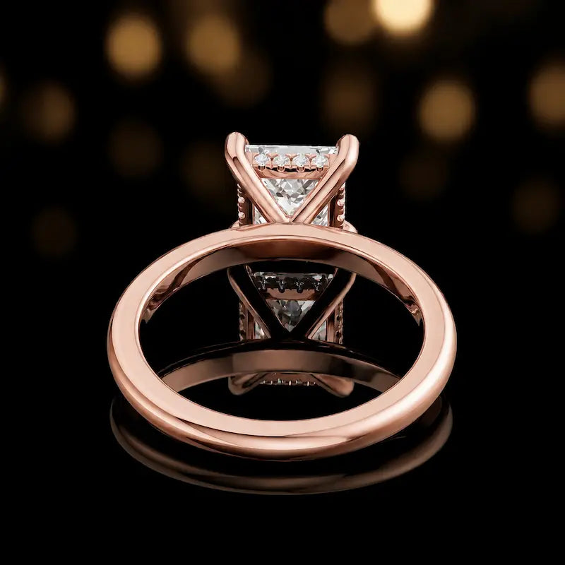Back view of 4-claw princess cut engagement ring with hidden halo in 18kt rose gold