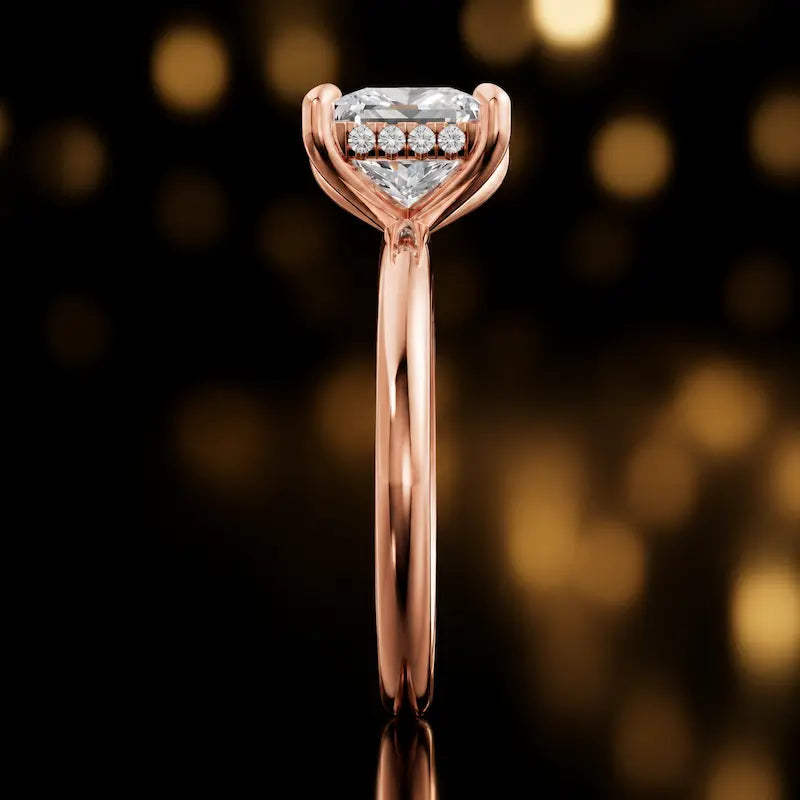 Side profile of 4-claw princess cut engagement ring with hidden halo in 18kt rose gold