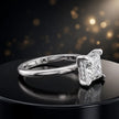 Angled view of 4-claw princess cut engagement ring with hidden halo in 18kt white gold