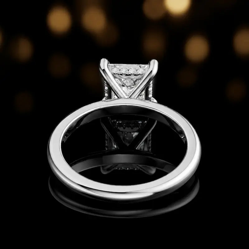 Back view of 4-claw princess cut engagement ring with hidden halo in 18kt white gold