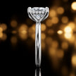 Side profile of 4-claw princess cut engagement ring with hidden halo in 18kt white gold