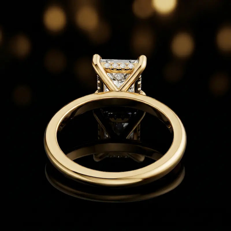Back view of 4-claw princess cut engagement ring with hidden halo in 18kt yellow gold