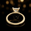 Back view of 4-claw princess cut engagement ring with hidden halo in 18kt yellow gold