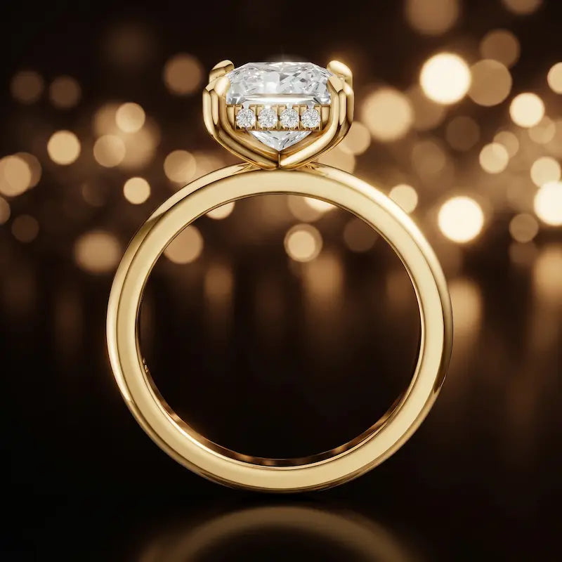 Front view of 4-claw princess cut engagement ring with hidden halo in 18kt yellow gold