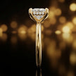 Side profile of 4-claw princess cut engagement ring with hidden halo in 18kt yellow gold