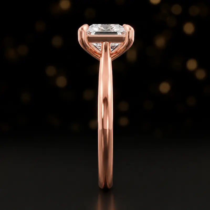 Side profile of a 1.5 carat princess cut diamond solitaire engagement ring showing the cathedral setting and 18kt rose gold band by TJ Diamond