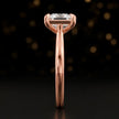 Side profile of a 1.5 carat princess cut diamond solitaire engagement ring showing the cathedral setting and 18kt rose gold band by TJ Diamond