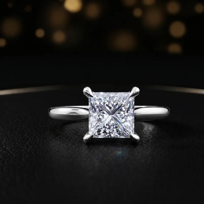 Front view of a 1.5 carat princess cut diamond solitaire engagement ring in an 18kt white gold 4 claw setting by TJ Diamond