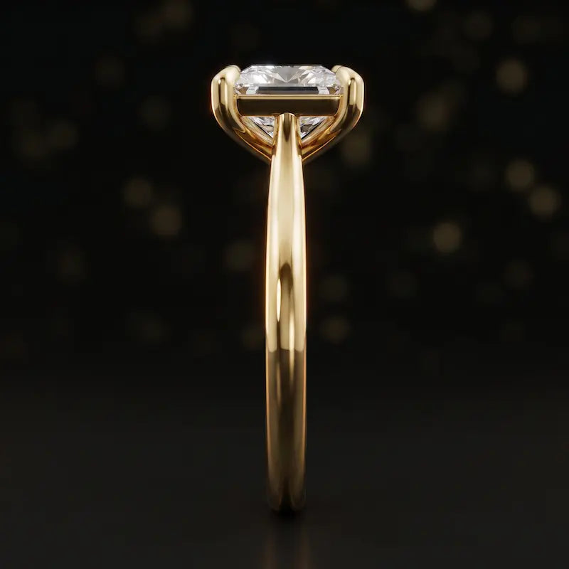 Side profile of a 1.5 carat princess cut diamond solitaire engagement ring showing the cathedral setting and 18kt yellow gold band by TJ Diamond