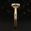 Side profile of a 1.5 carat princess cut diamond solitaire engagement ring showing the cathedral setting and 18kt yellow gold band by TJ Diamond