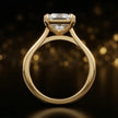 Front-on view of a 1.5 carat princess cut diamond solitaire engagement ring showing the full 18kt yellow gold band and 4 claw cathedral setting by TJ Diamond