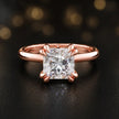 Front view of a 1.5 carat princess cut diamond solitaire engagement ring in an 18kt rose gold 4 double claw setting by TJ Diamond