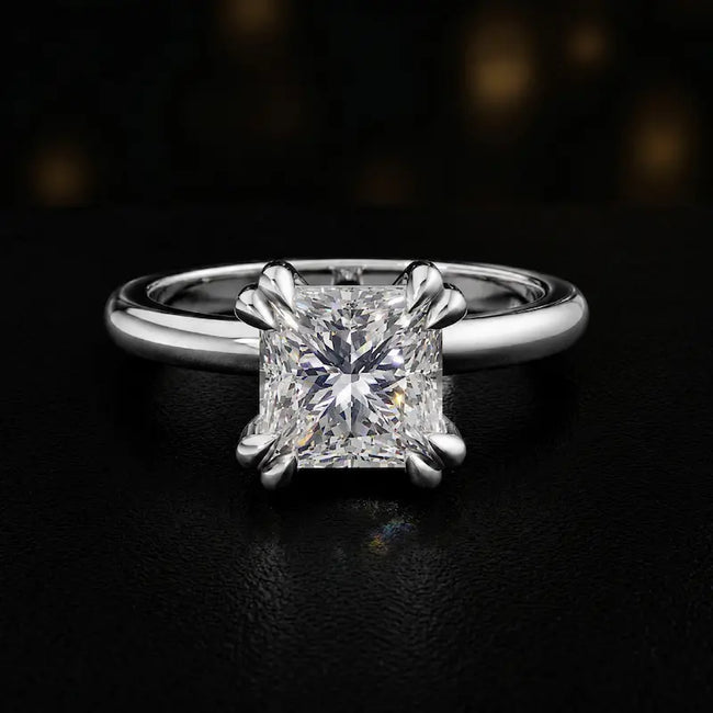 Front view of a 1.5 carat princess cut diamond solitaire engagement ring in an 18kt white gold 4 double claw setting by TJ Diamond