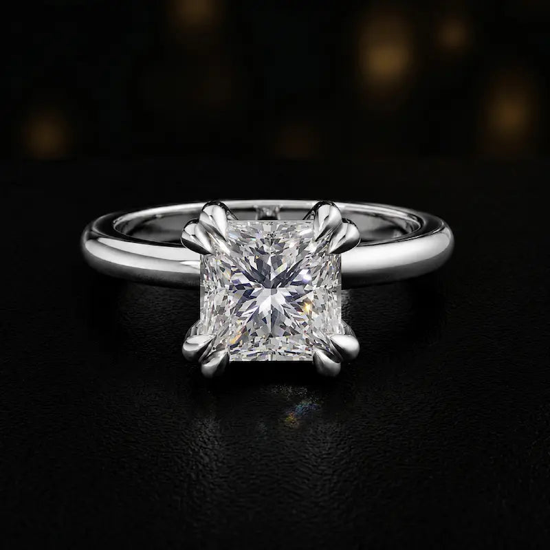 Front view of a 1.5 carat princess cut diamond solitaire engagement ring in an 18kt white gold 4 double claw setting by TJ Diamond