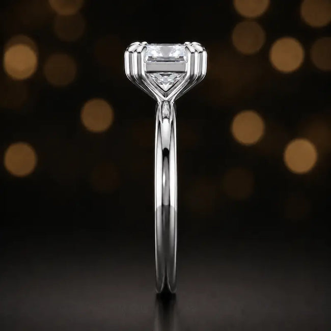 Side profile of a 1.5 carat princess cut diamond solitaire engagement ring showing the 4 double claw setting and 18kt white gold band by TJ Diamond