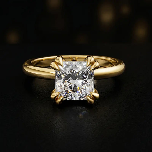 Front view of a 1.5 carat princess cut diamond solitaire engagement ring in an 18kt yellow gold 4 double claw setting by TJ Diamond