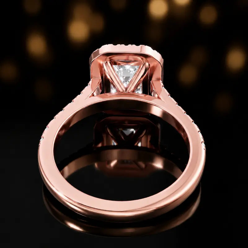 Rear view of an emerald cut halo lab-grown diamond engagement ring in 18kt rose gold.