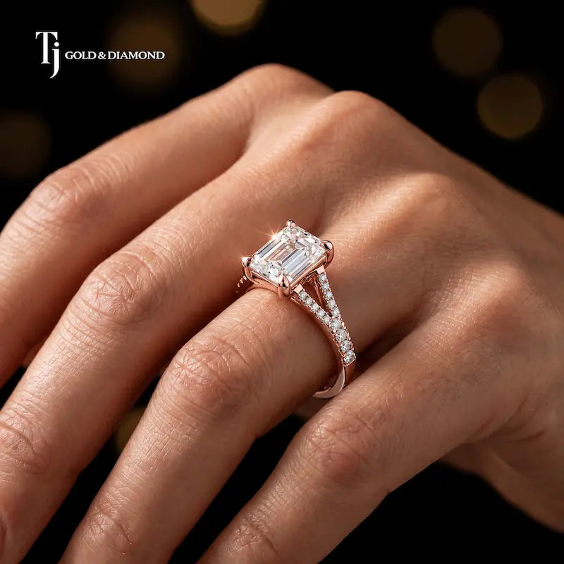 Emerald cut split shank lab-grown diamond engagement ring worn on hand in 18kt rose gold.