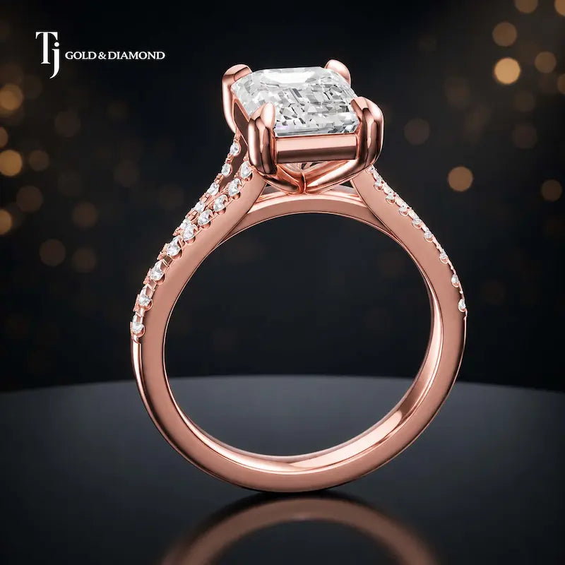 Side view of an emerald cut split shank lab-grown diamond engagement ring featuring a four-claw cathedral setting in 18kt rose gold.