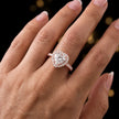 Heart cut halo lab-grown diamond engagement ring worn on hand in 18kt rose gold.