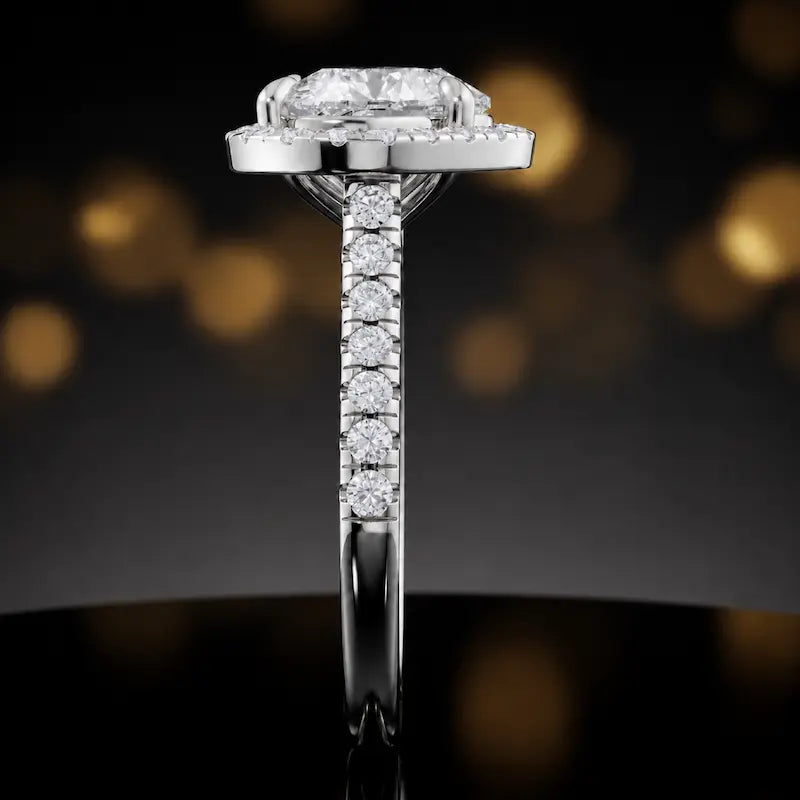 Side profile of a heart cut halo lab-grown diamond engagement ring in 18kt white gold.
