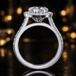Side view of a heart cut halo lab-grown diamond engagement ring with diamond-set shoulders in 18kt white gold.