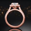 Side view of a marquise cut halo lab-grown diamond engagement ring with diamond-set shoulders in 18kt rose gold.