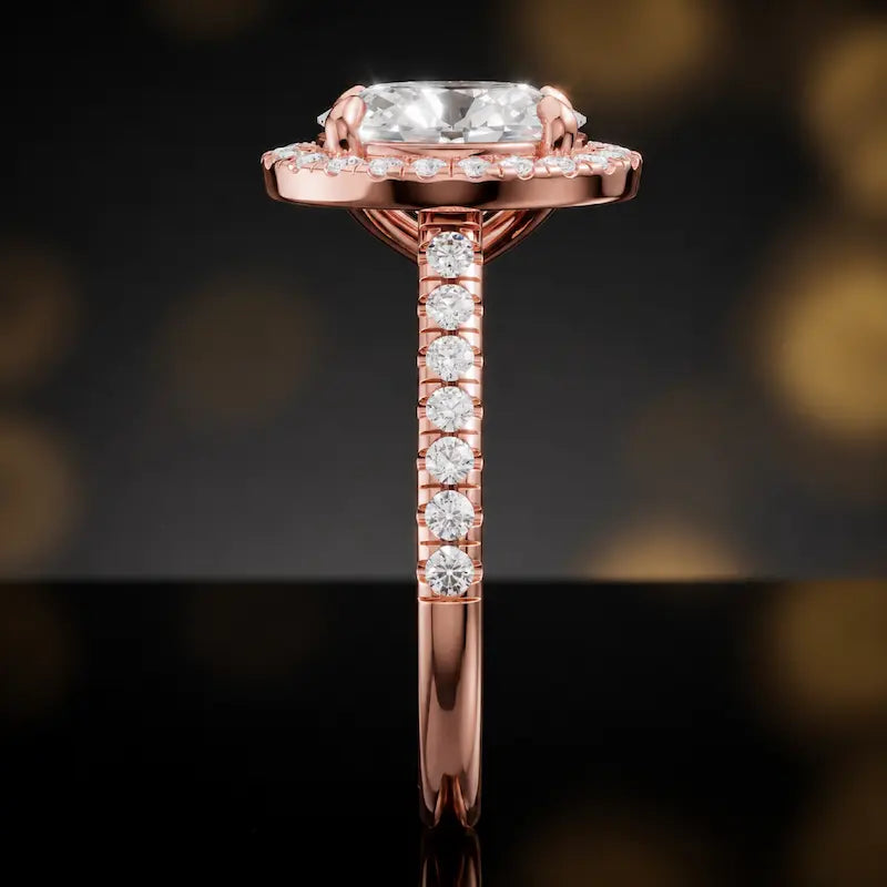 Side profile of an oval cut halo lab-grown diamond engagement ring in 18kt rose gold.