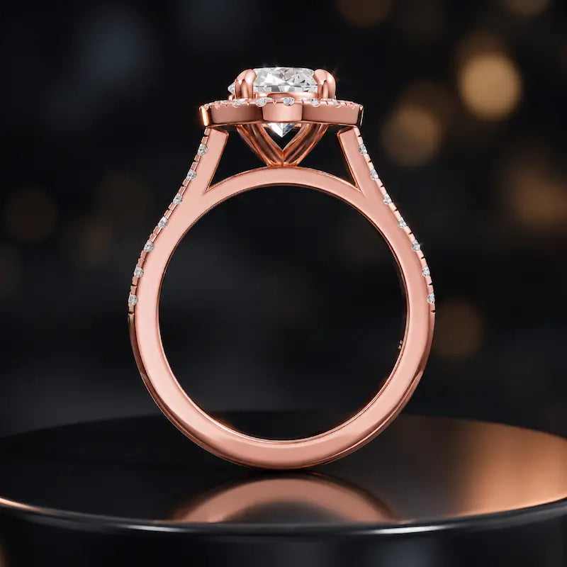 Side view of an oval cut halo lab-grown diamond engagement ring with diamond-set shoulders in 18kt rose gold.