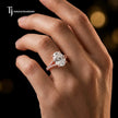 Oval cut split shank lab-grown diamond engagement ring worn on hand in 18kt rose gold.