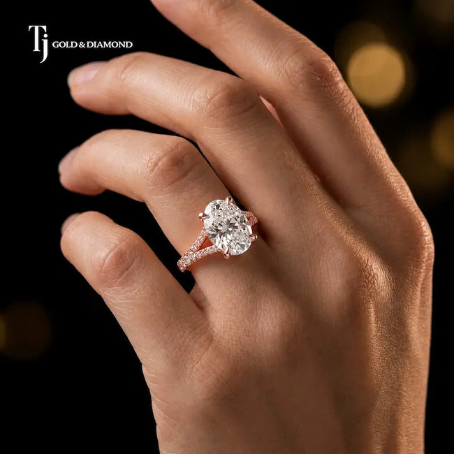 Oval cut split shank lab-grown diamond engagement ring worn on hand in 18kt rose gold.
