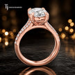 Side view of an oval cut split shank lab-grown diamond engagement ring featuring a four-claw cathedral setting in 18kt rose gold.